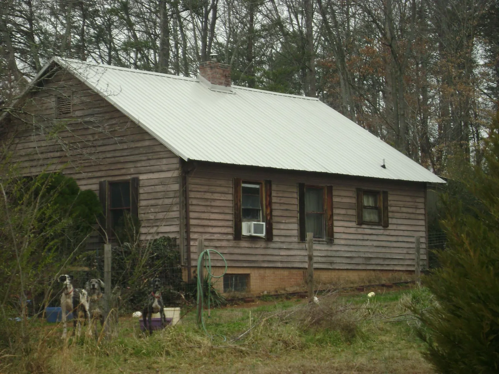 White metal roof on an old wood sided farmhouse, from a Metal Roof Installation job in Hope